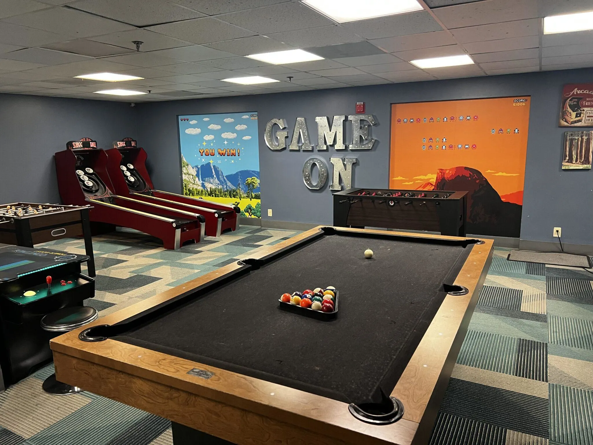 Game room with pool table in the middle