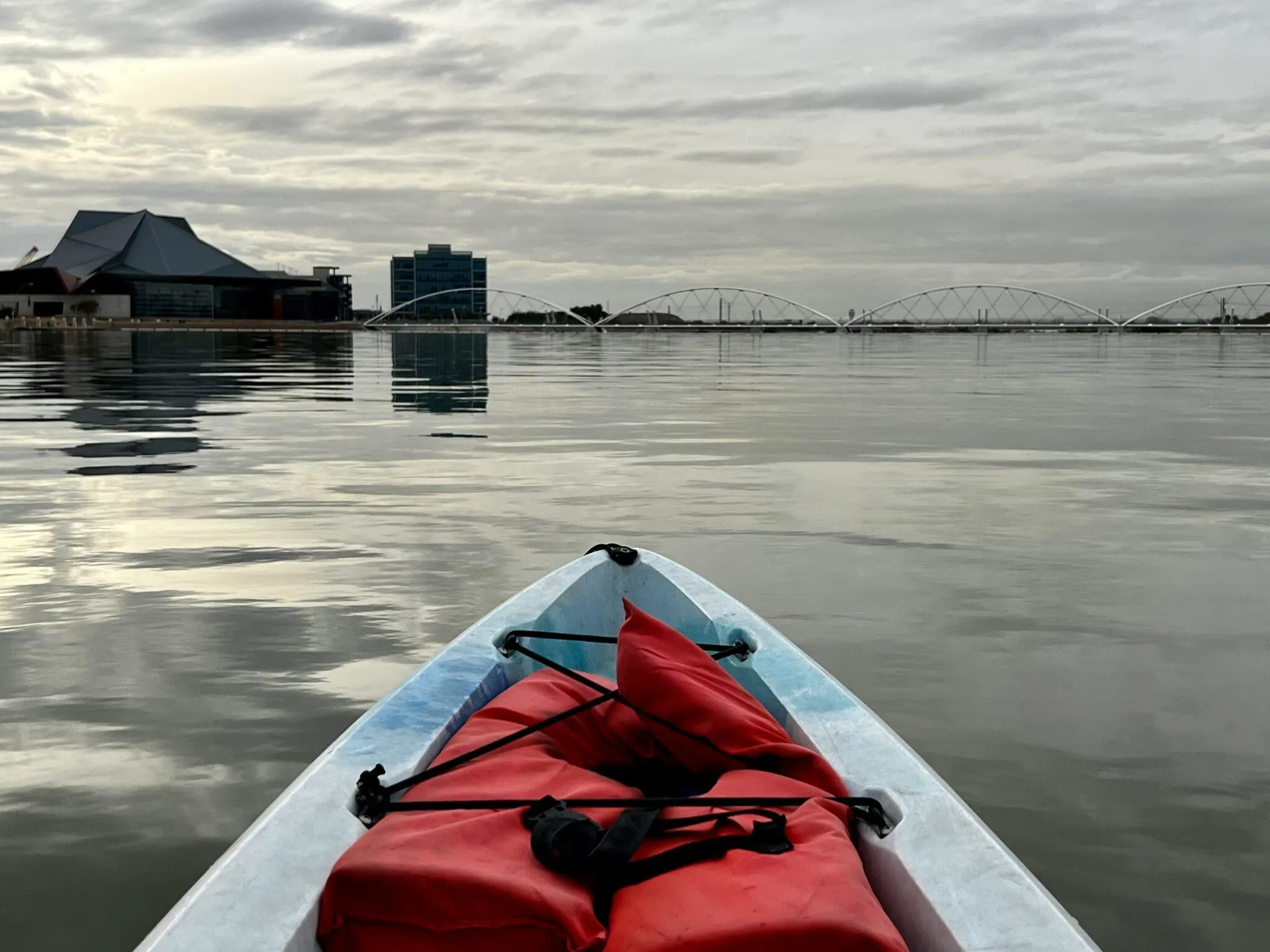 Kayak in water with red life vest