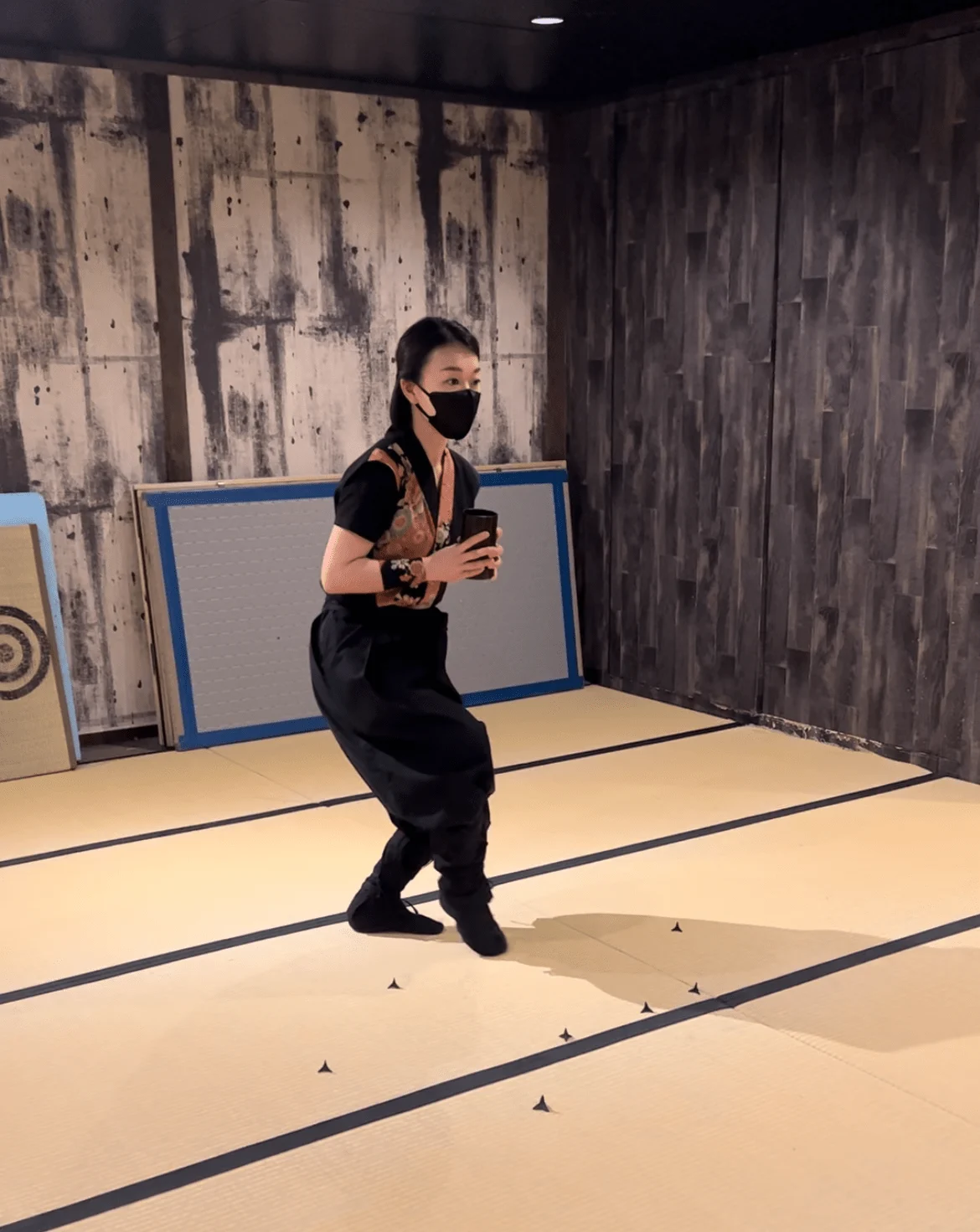 Ninja instructor dodging obstacles on floor