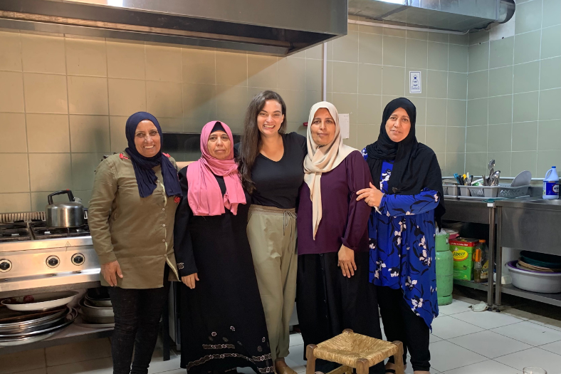 5 women, one American, posing for a picture