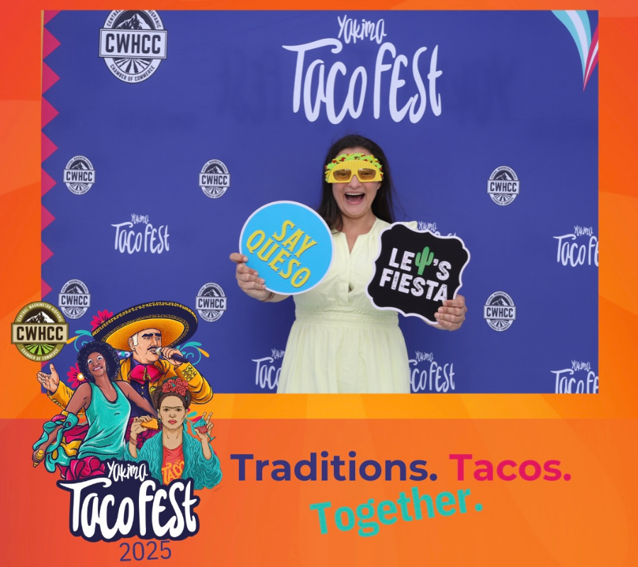Woman holding up photo booth signs at Yakima Valley TacoFest