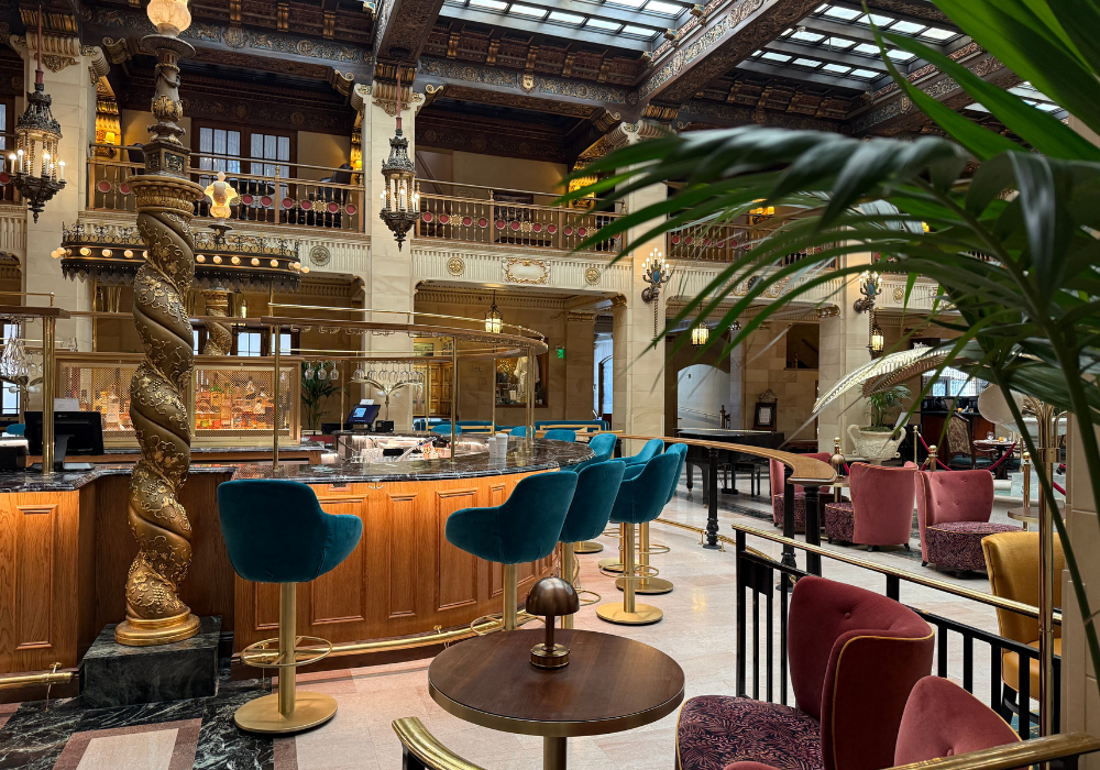 Teal velvet seats around a gold bar