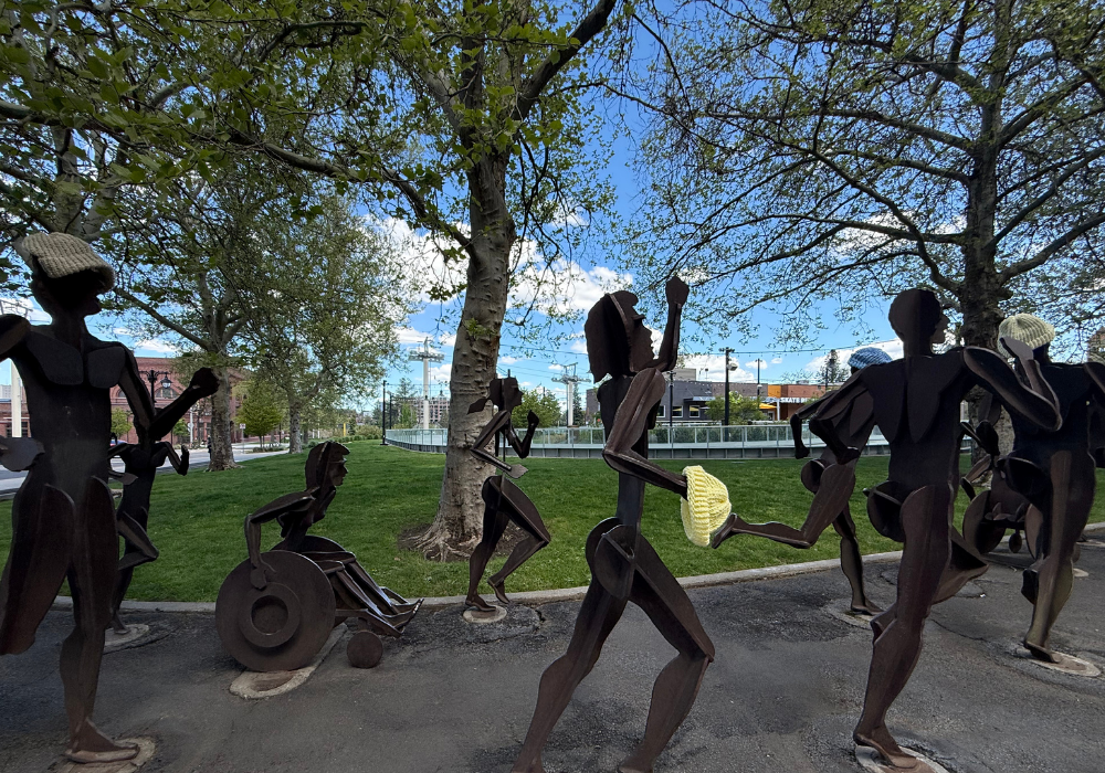 Statue of people running, including wheelchair