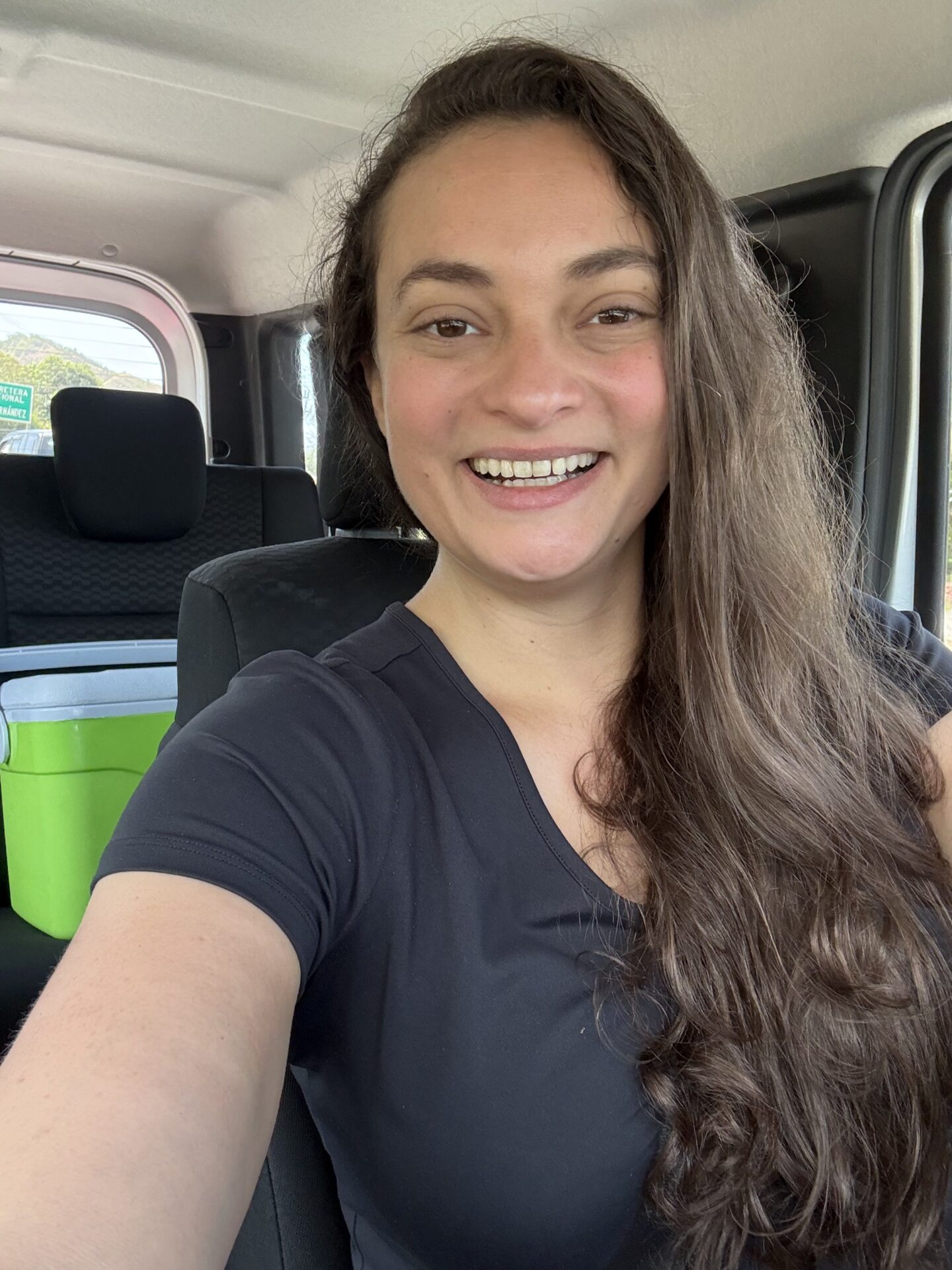 Driving in Vamos compact SUV with cooler in back seat