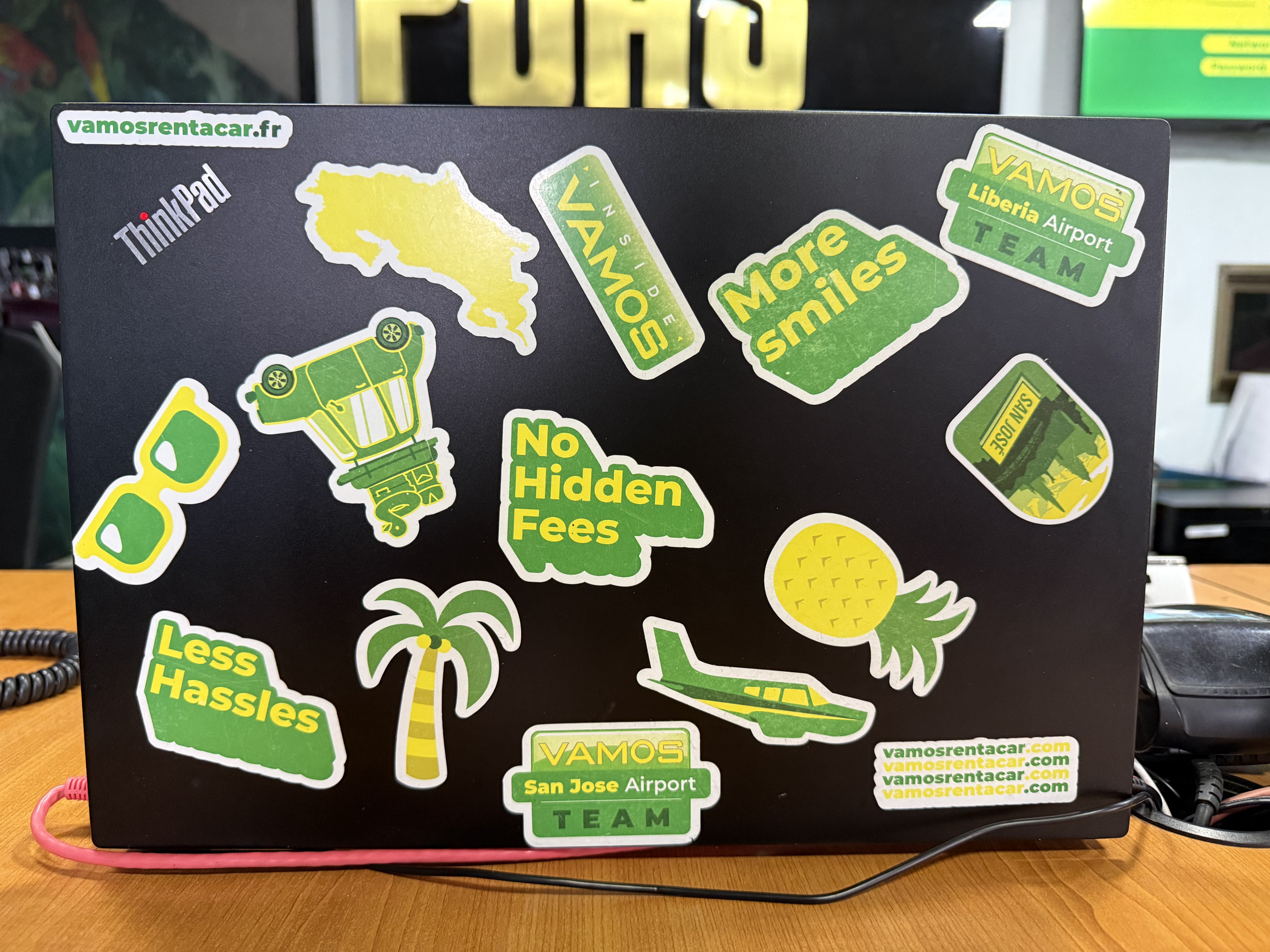 Laptop with Vamos Rent-A-Car stickers
