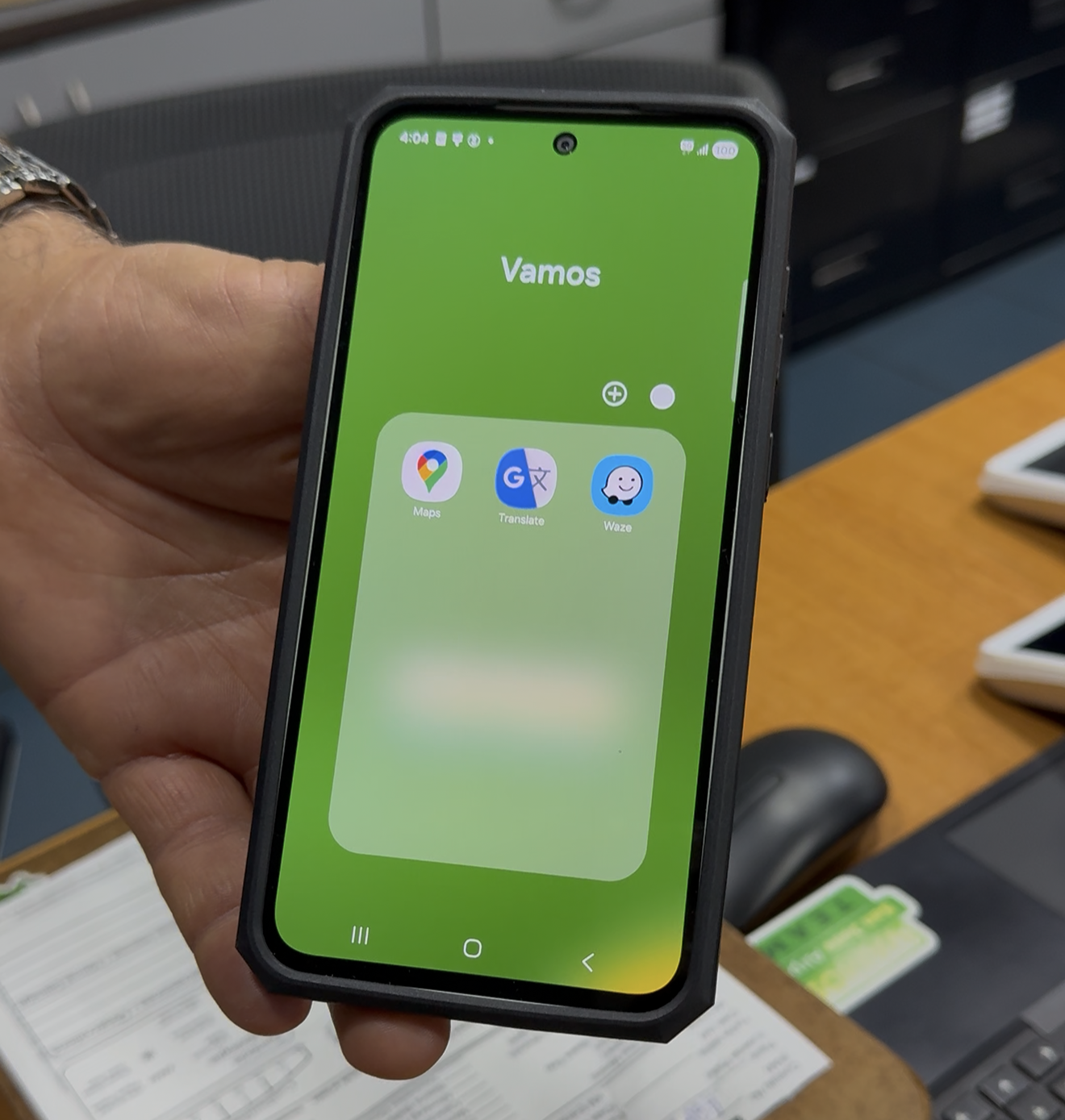 Man holding phone with navigation apps folder open