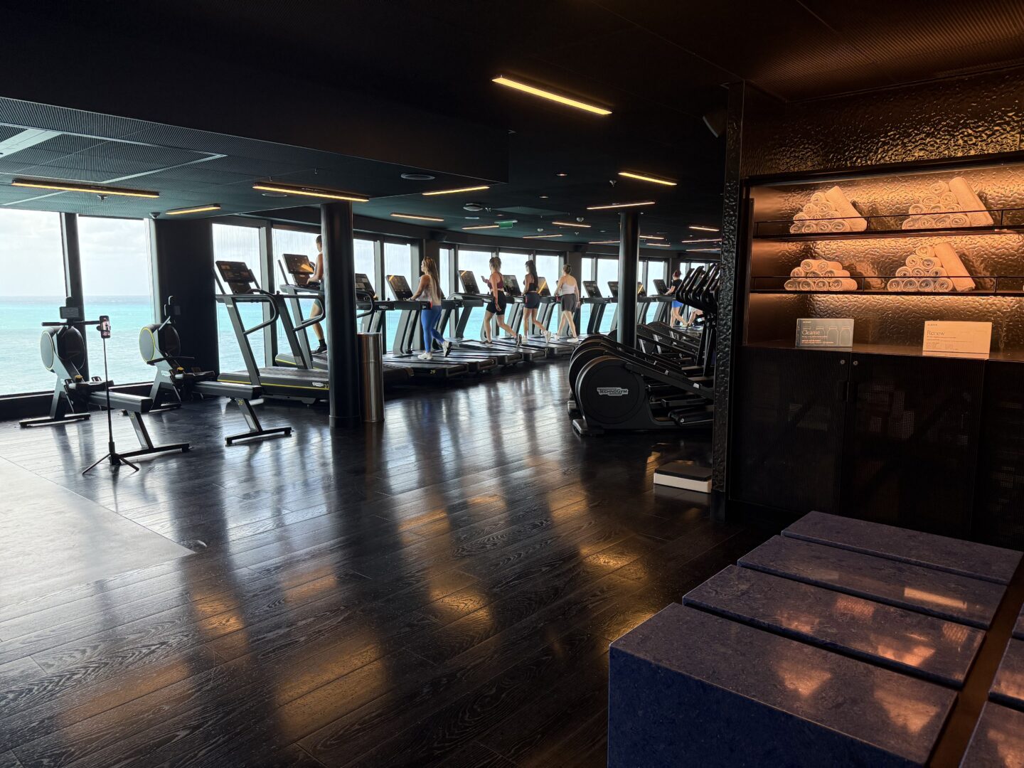 Gym with treadmills and neatly stacked towels